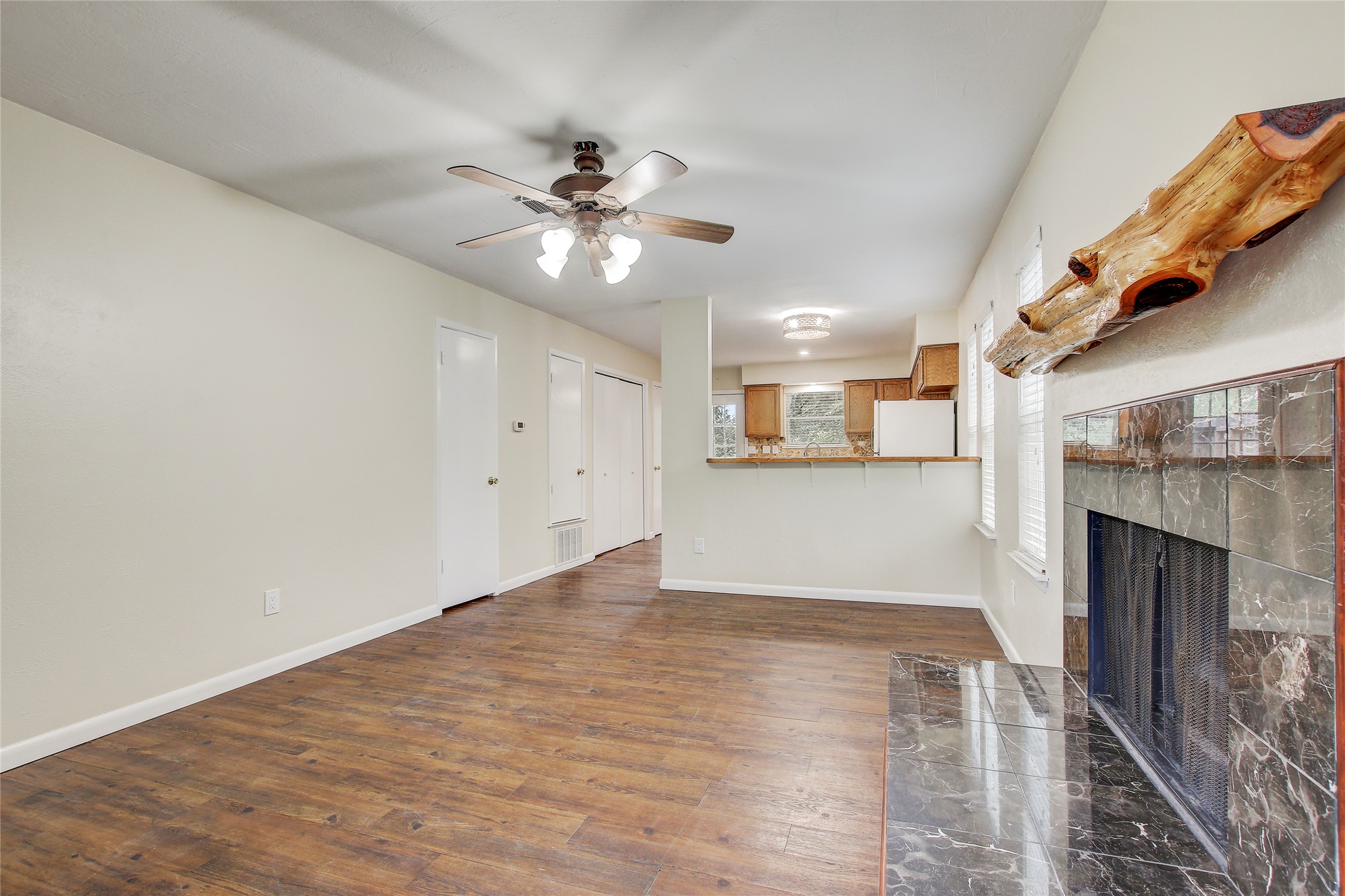 6902 Rifle Bend, Unit B Austin, TX 78736 - Photo 3 of 34 a view of empty room with wooden floor and fireplace