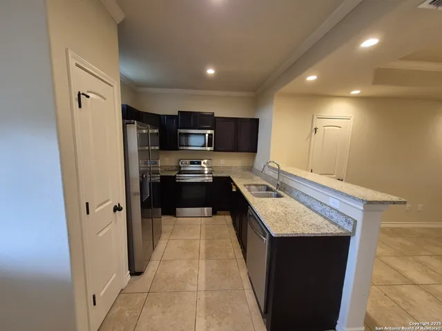 a kitchen with kitchen island a counter top space appliances and cabinets