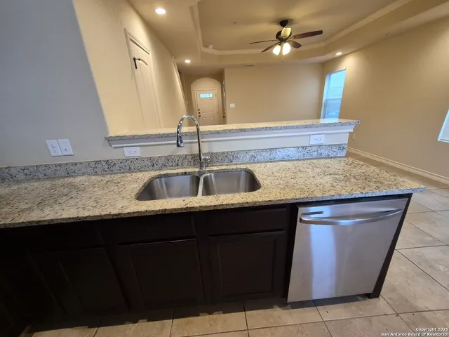 a kitchen with a sink and a refrigerator