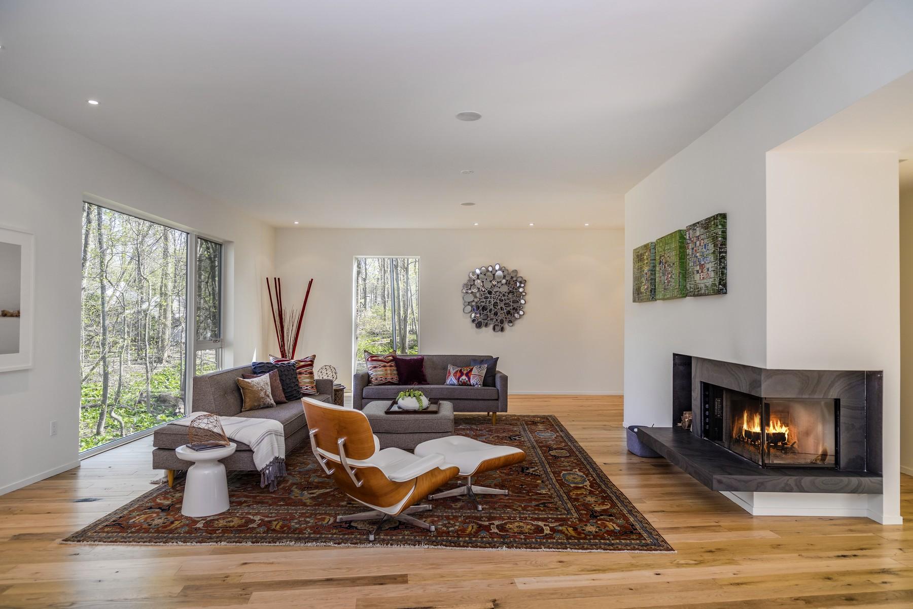 364 Hollow Tree Ridge Road Darien, CT 06820 - Photo 6 of 31 a living room with furniture large window and a fireplace