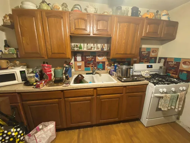 a kitchen with a sink cabinets and appliances