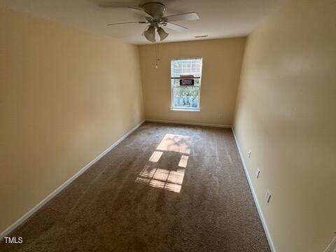 1311 Canyon Rock Court, Unit 105 Raleigh, NC 27610 - Photo 8 of 11 an empty room with windows and ceiling fan view