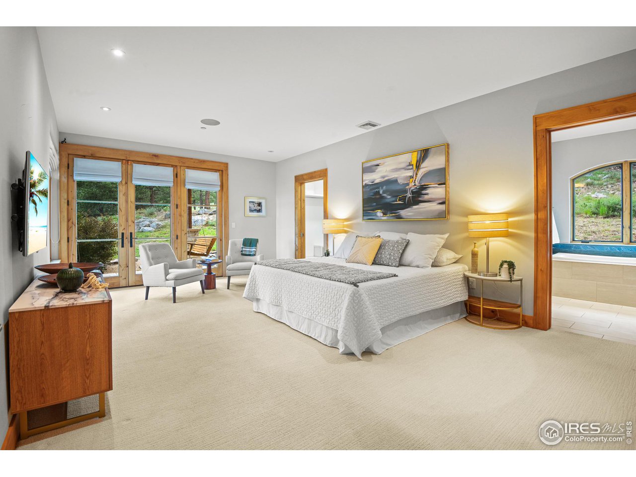 575 Reed Ranch Road Boulder, CO 80302 - Photo 18 of 40 a spacious bedroom with a bed a couch and large window