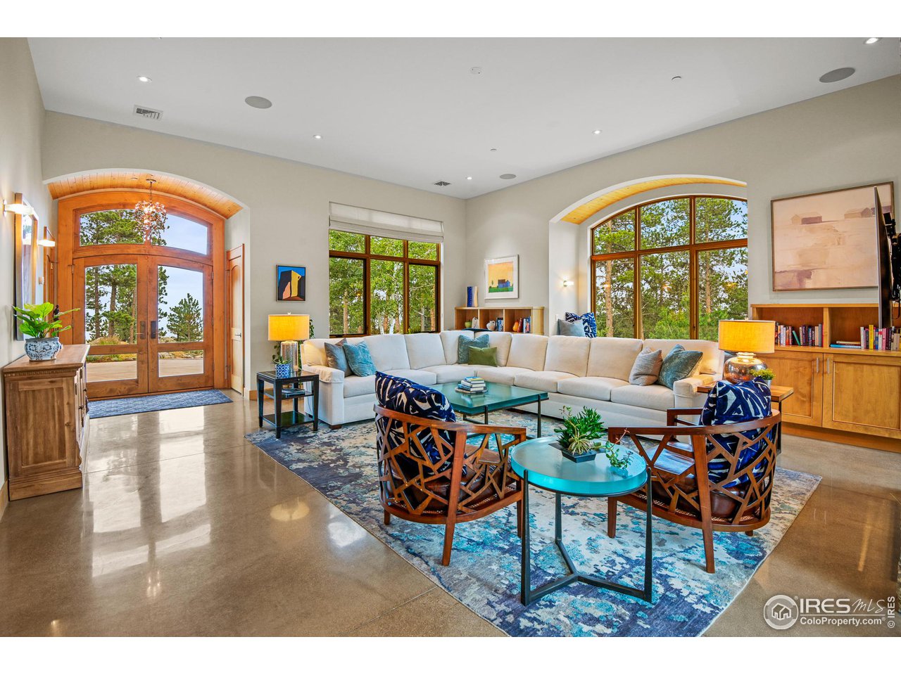 575 Reed Ranch Road Boulder, CO 80302 - Photo 3 of 40 a living room with furniture a large window and wooden floor