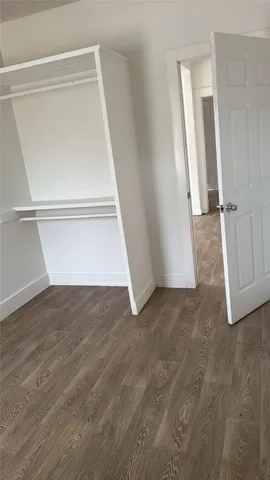 a view of closet with wooden floor