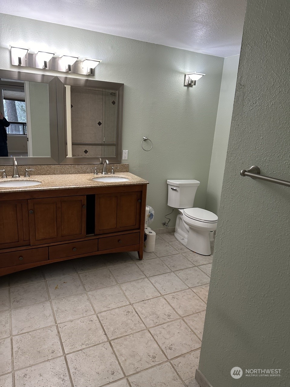 2106 37th Street Bellingham, WA 98229 - Photo 18 of 32 a bathroom with a sink a toilet and a mirror