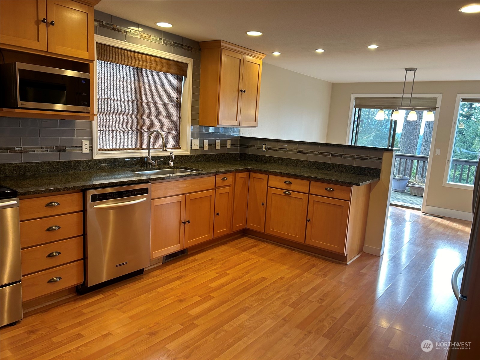 2106 37th Street Bellingham, WA 98229 - Photo 7 of 32 a kitchen with stainless steel appliances granite countertop wooden cabinets and a sink