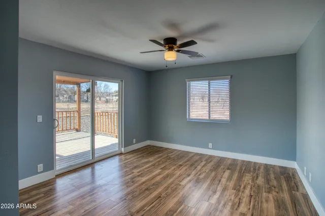 wooden floor in an empty room with a window