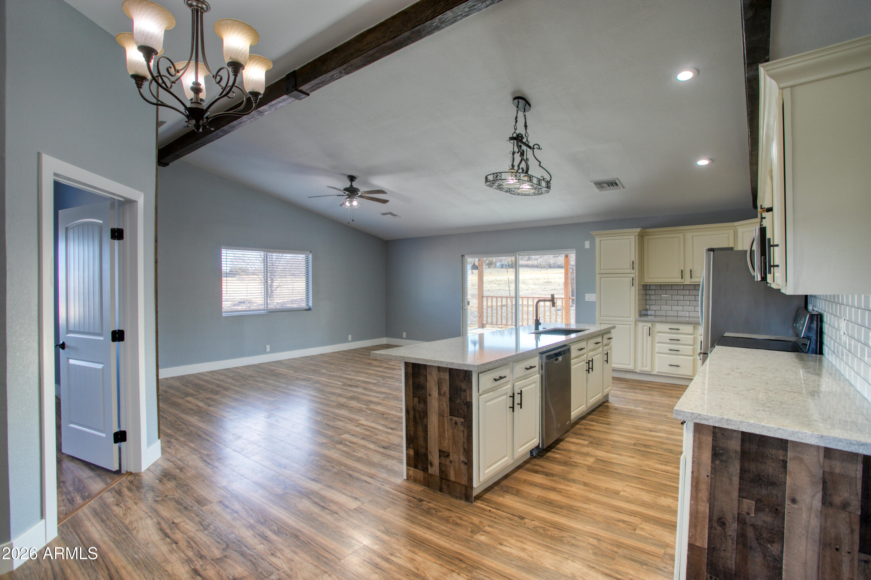 97 Mulligan Road Eagar, AZ 85925 - Photo 4 of 27 a large kitchen with stainless steel appliances granite countertop a oven and a wooden floors