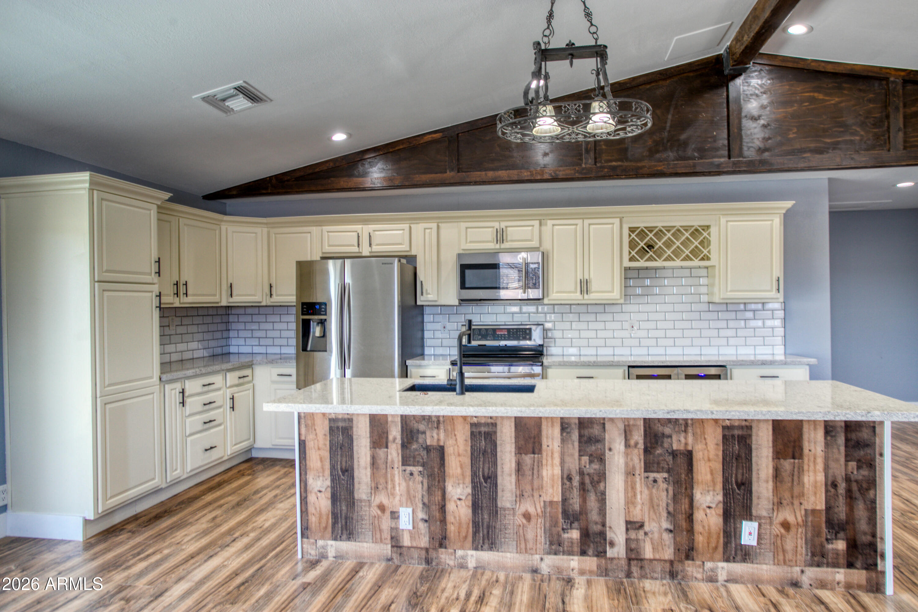 97 Mulligan Road Eagar, AZ 85925 - Photo 6 of 27 a kitchen with stainless steel appliances granite countertop a refrigerator a stove and a sink with wooden floor