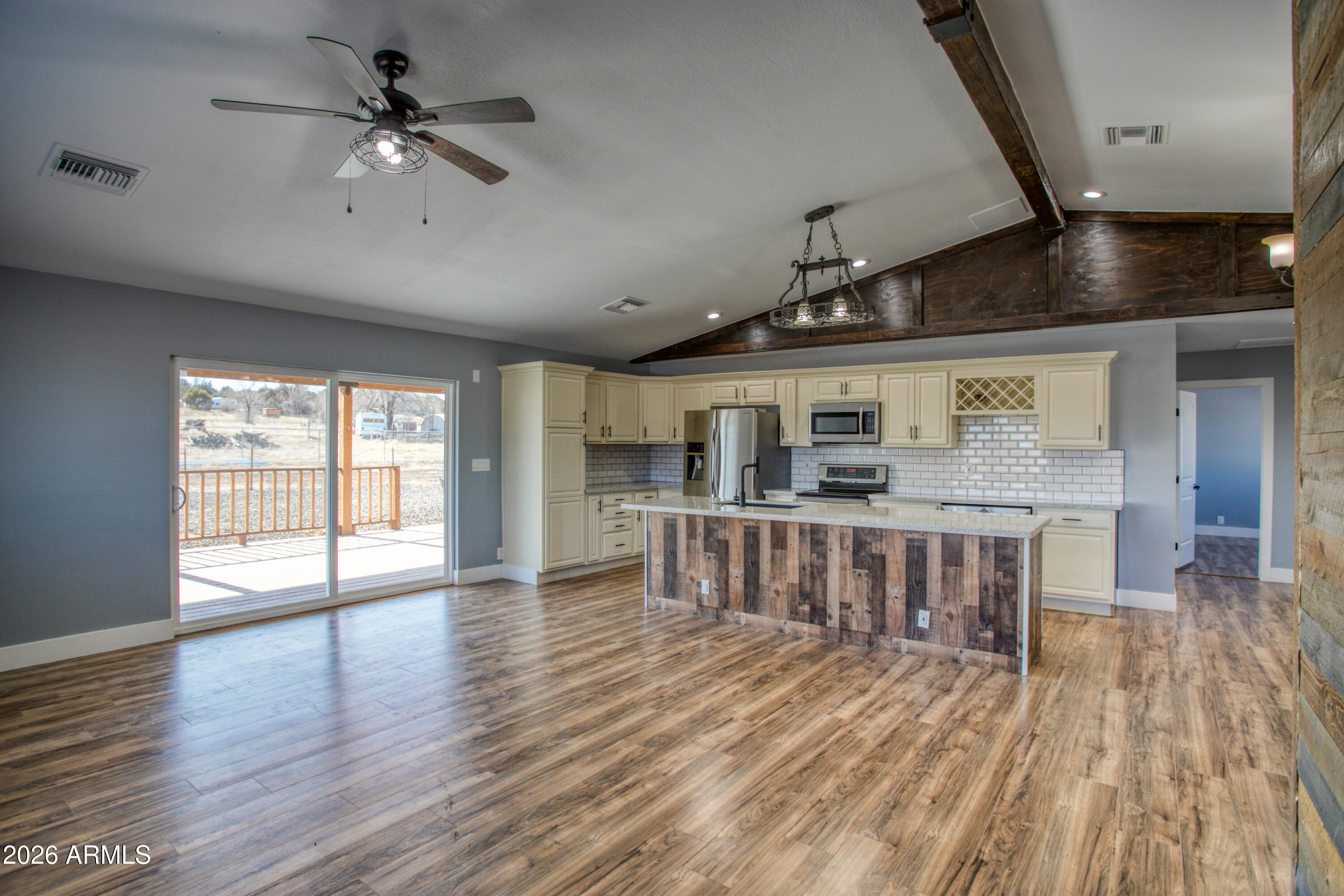 97 Mulligan Road Eagar, AZ 85925 - Photo 7 of 27 a view of an empty room with wooden floor and a window