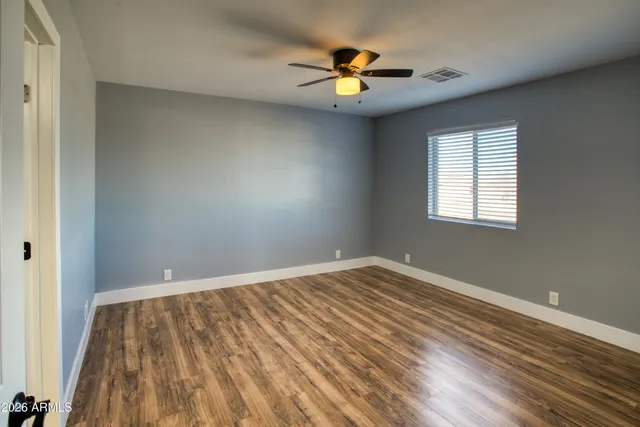 wooden floor in an empty room with a window