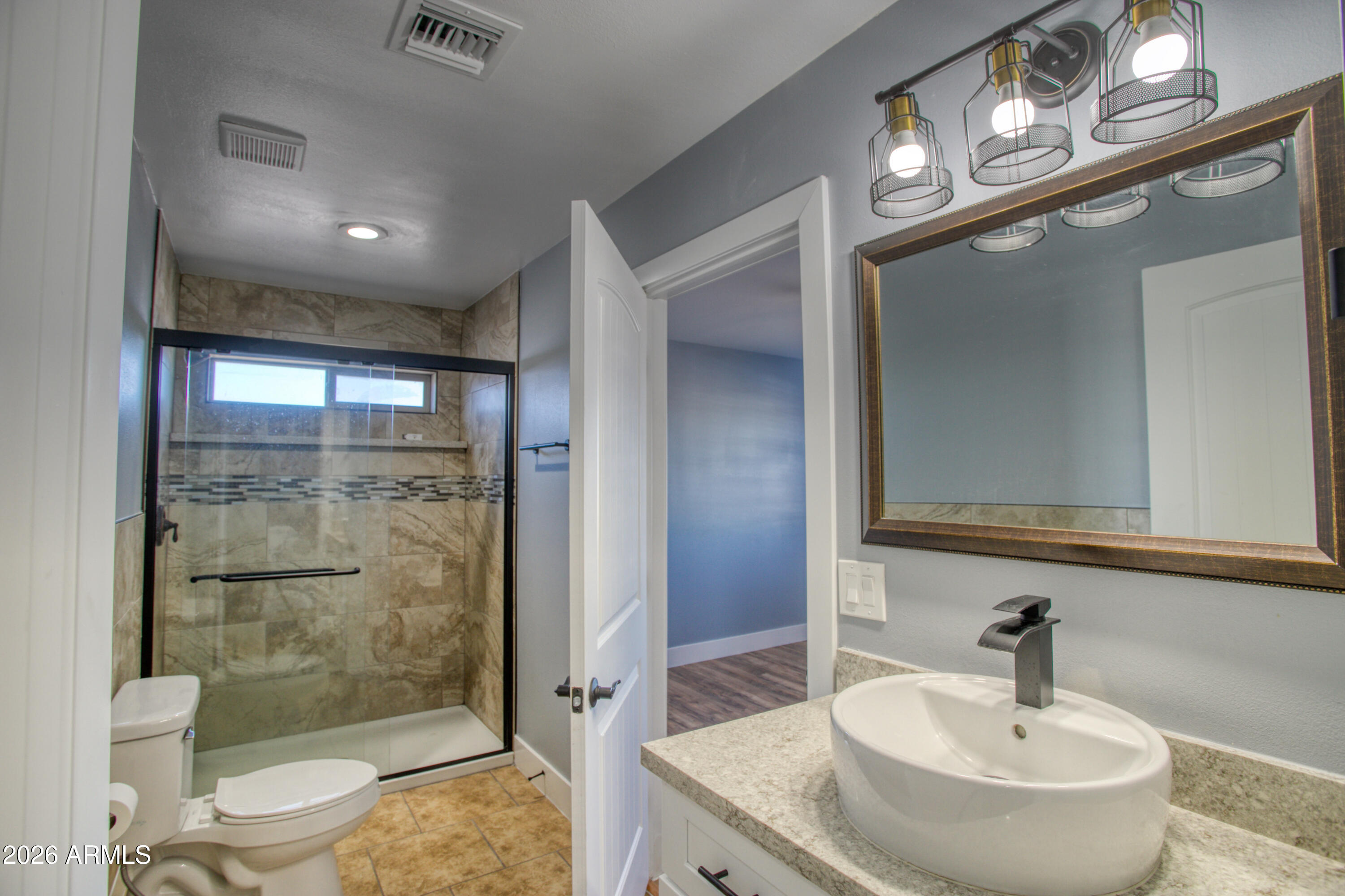 97 Mulligan Road Eagar, AZ 85925 - Photo 10 of 27 a bathroom with a sink a toilet and shower