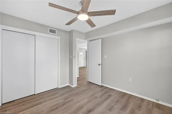 a view of an empty room with wooden floor