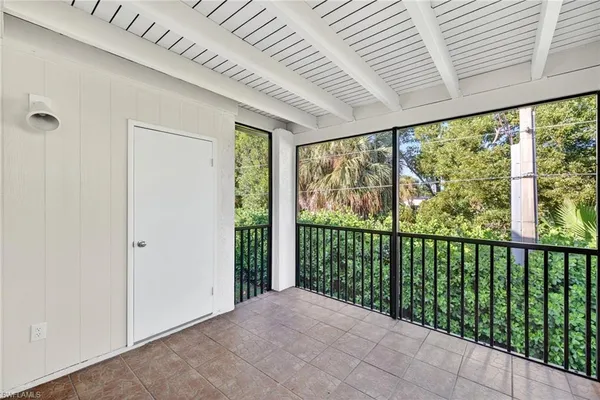 a view of a porch with a floor to ceiling window