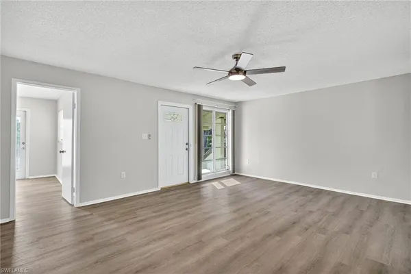 a view of an empty room with wooden floor