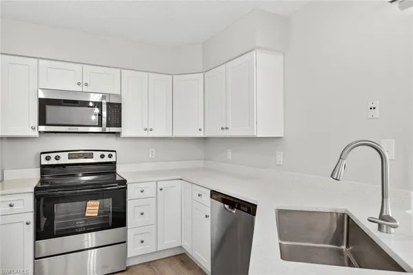 a kitchen with granite countertop a stove and a sink