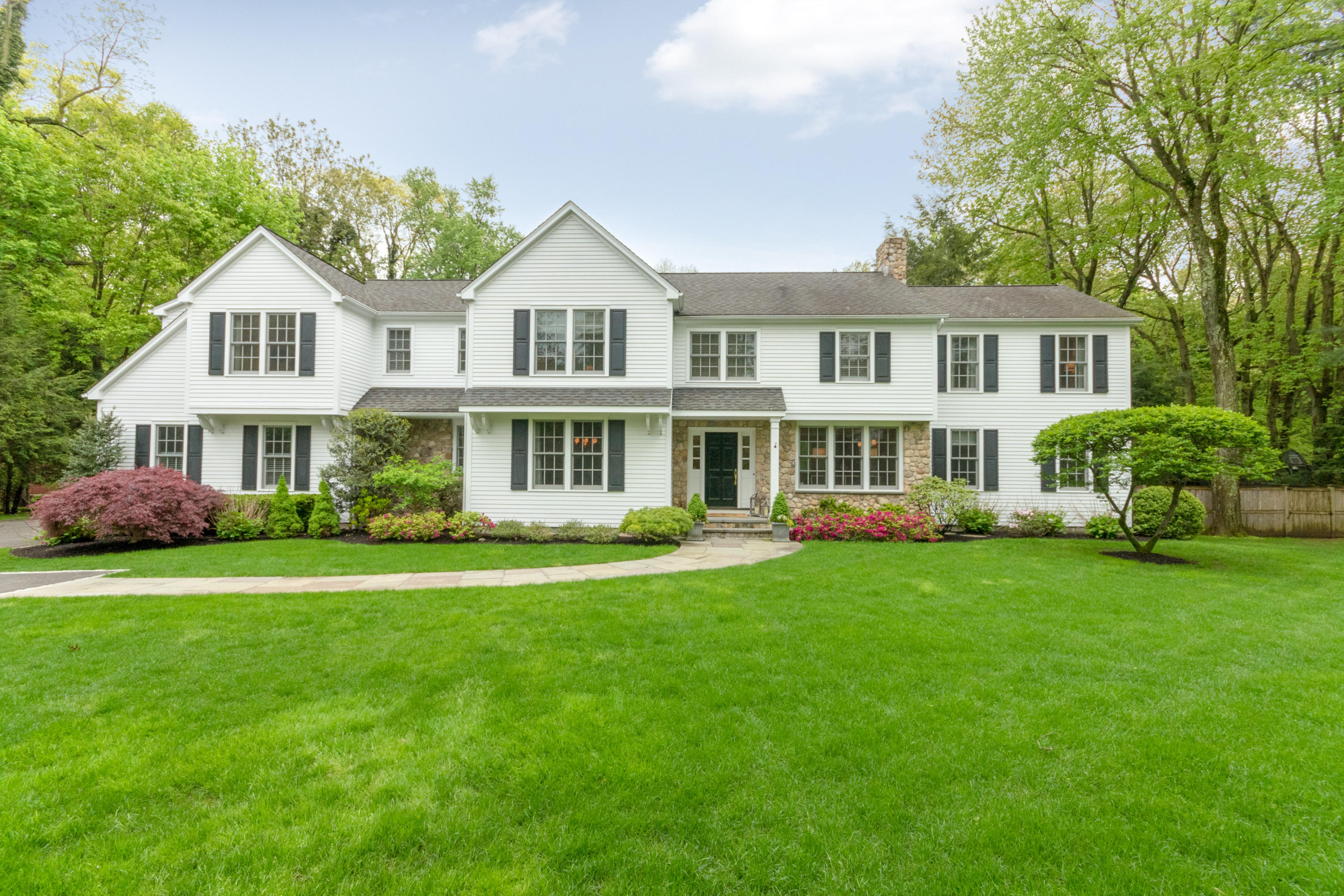a front view of a house with a garden