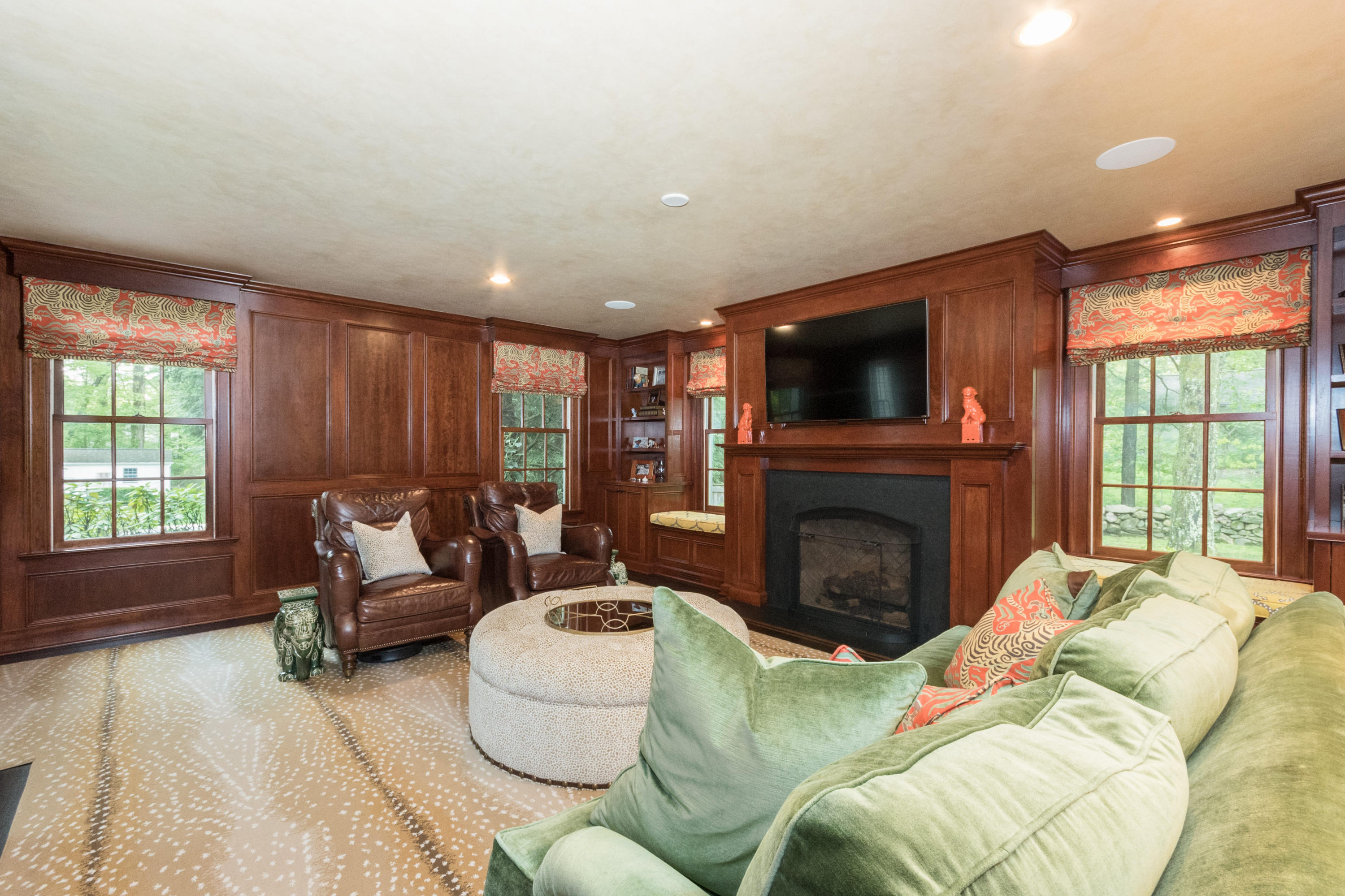 280 Hollow Tree Ridge Road Darien, CT 06820 - Photo 15 of 66 a living room with furniture a fireplace and a flat screen tv