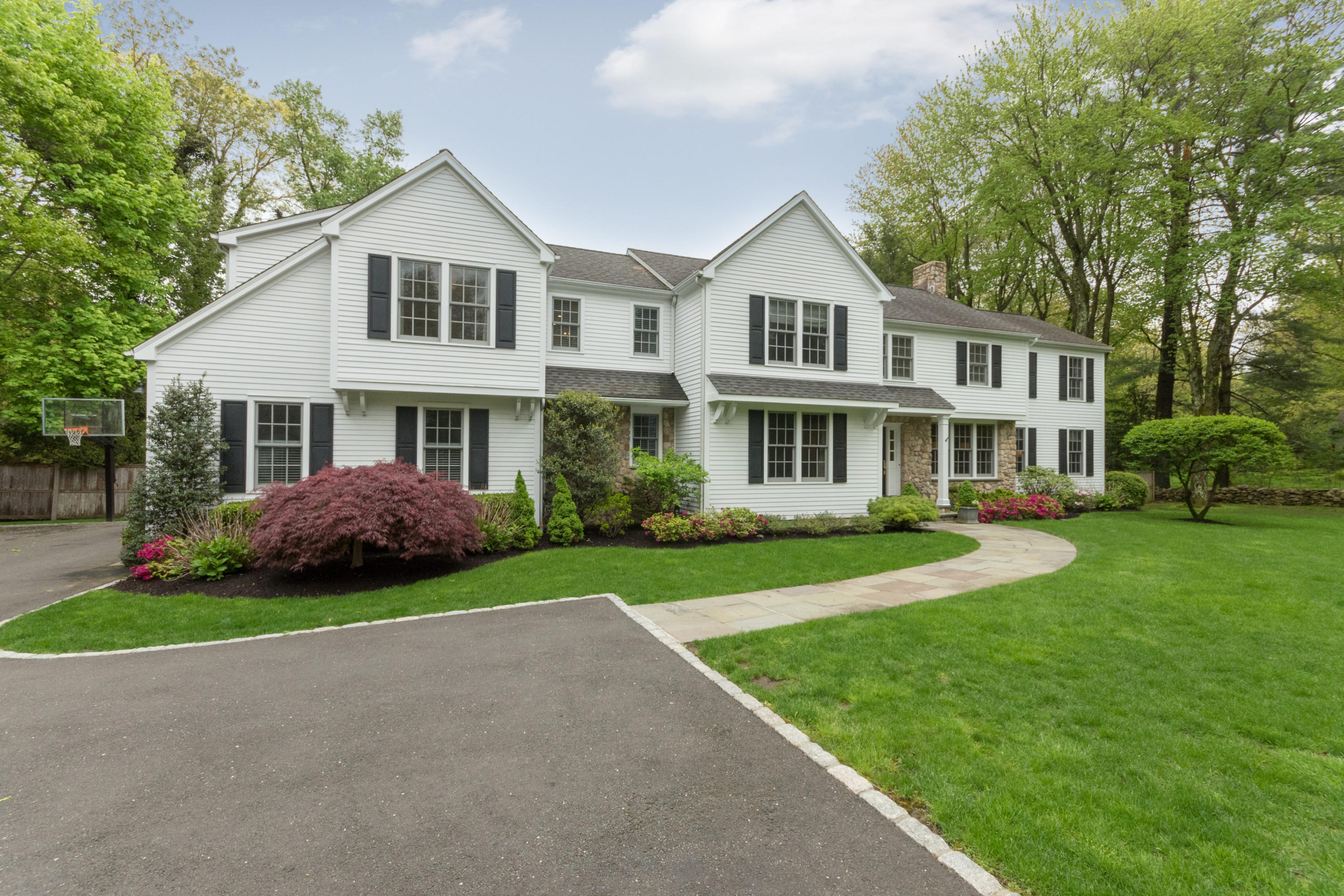 280 Hollow Tree Ridge Road Darien, CT 06820 - Photo 3 of 66 a front view of a house with a yard and garage