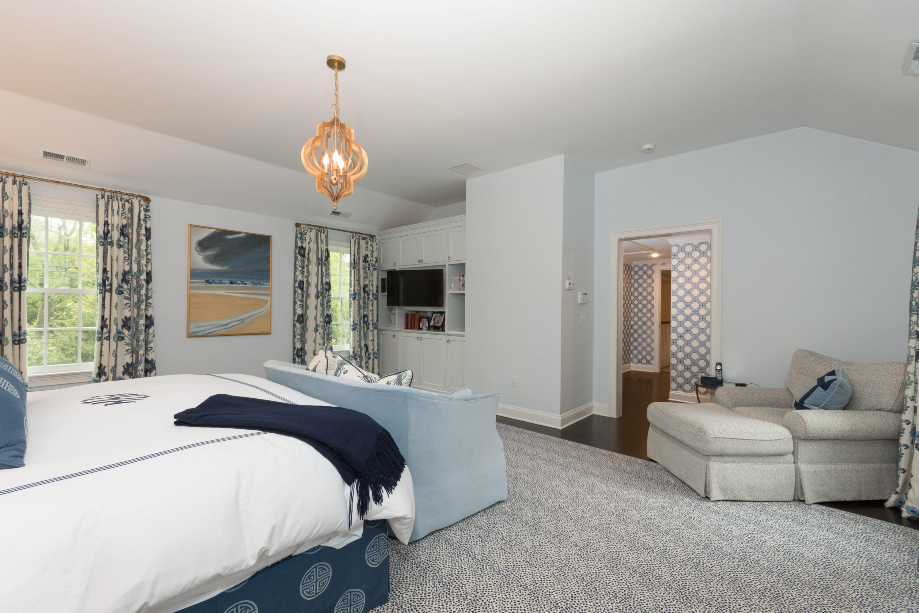 280 Hollow Tree Ridge Road Darien, CT 06820 - Photo 31 of 66 a spacious bedroom with a bed and a chandelier