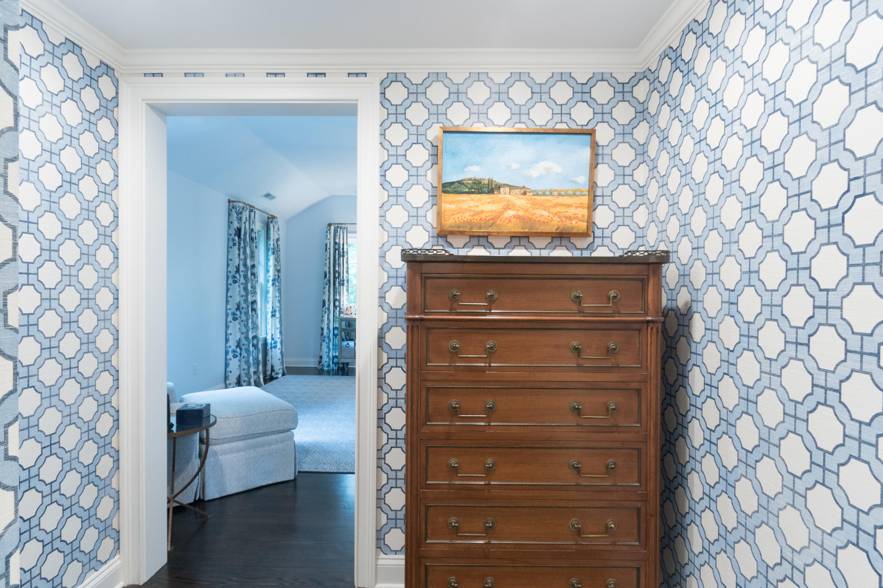 280 Hollow Tree Ridge Road Darien, CT 06820 - Photo 32 of 66 a view of a hallway with two couches and a bookshelf with wooden floor