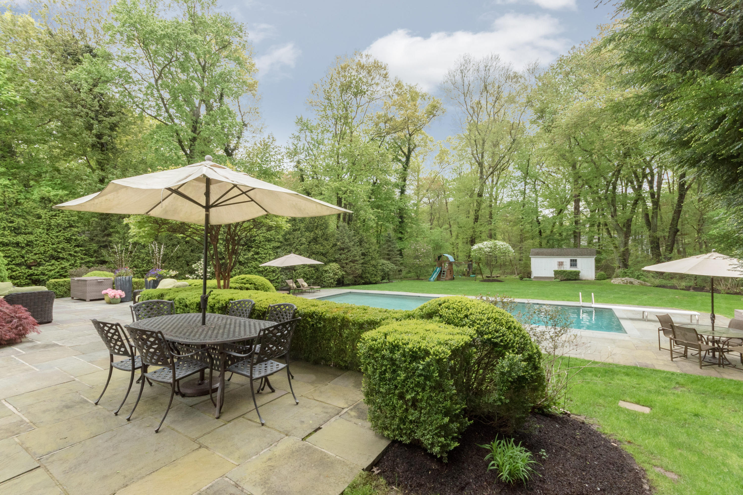 280 Hollow Tree Ridge Road Darien, CT 06820 - Photo 54 of 66 a view of a table and chairs under an umbrella