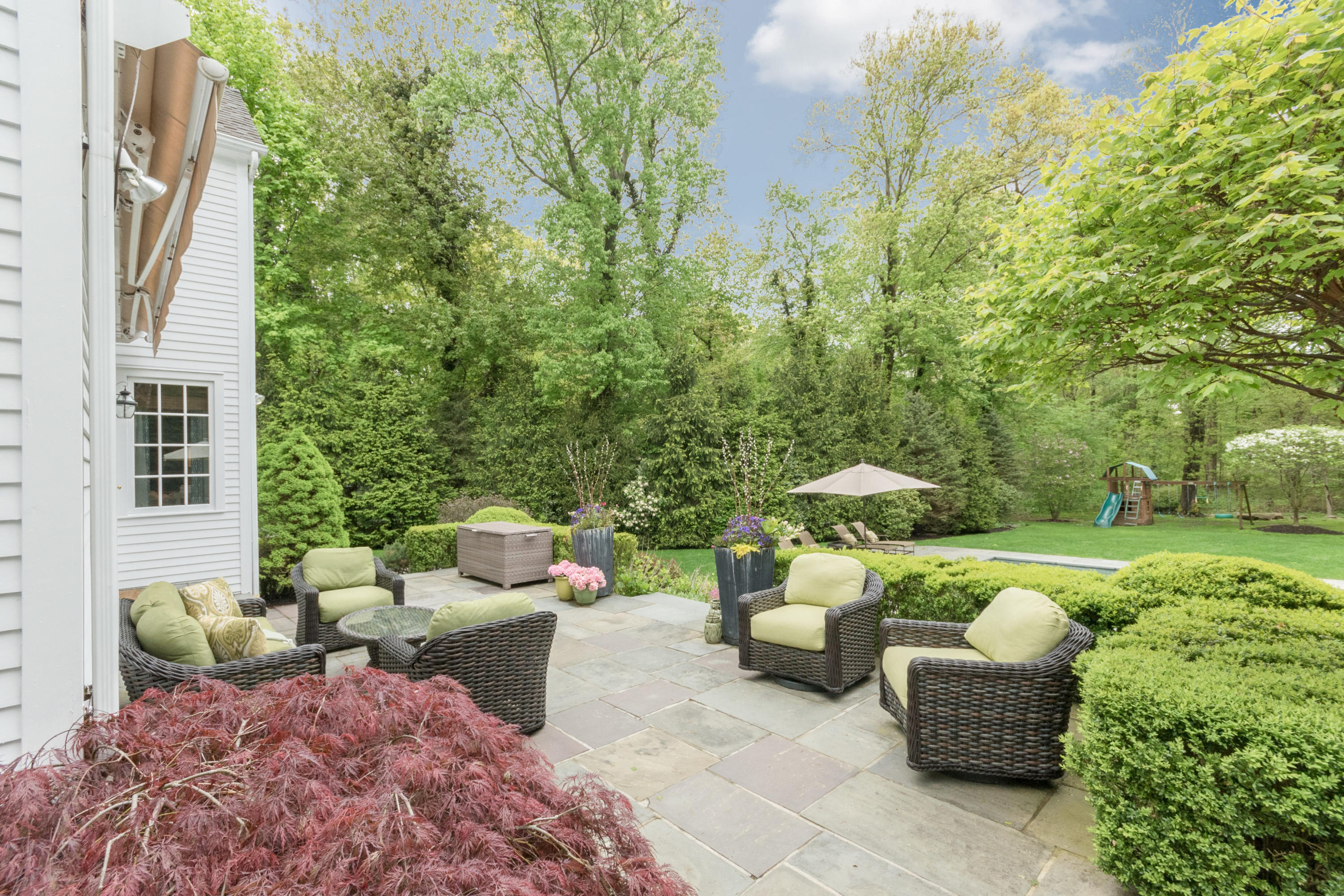 280 Hollow Tree Ridge Road Darien, CT 06820 - Photo 55 of 66 a view of a patio with couches table and chairs and potted plants