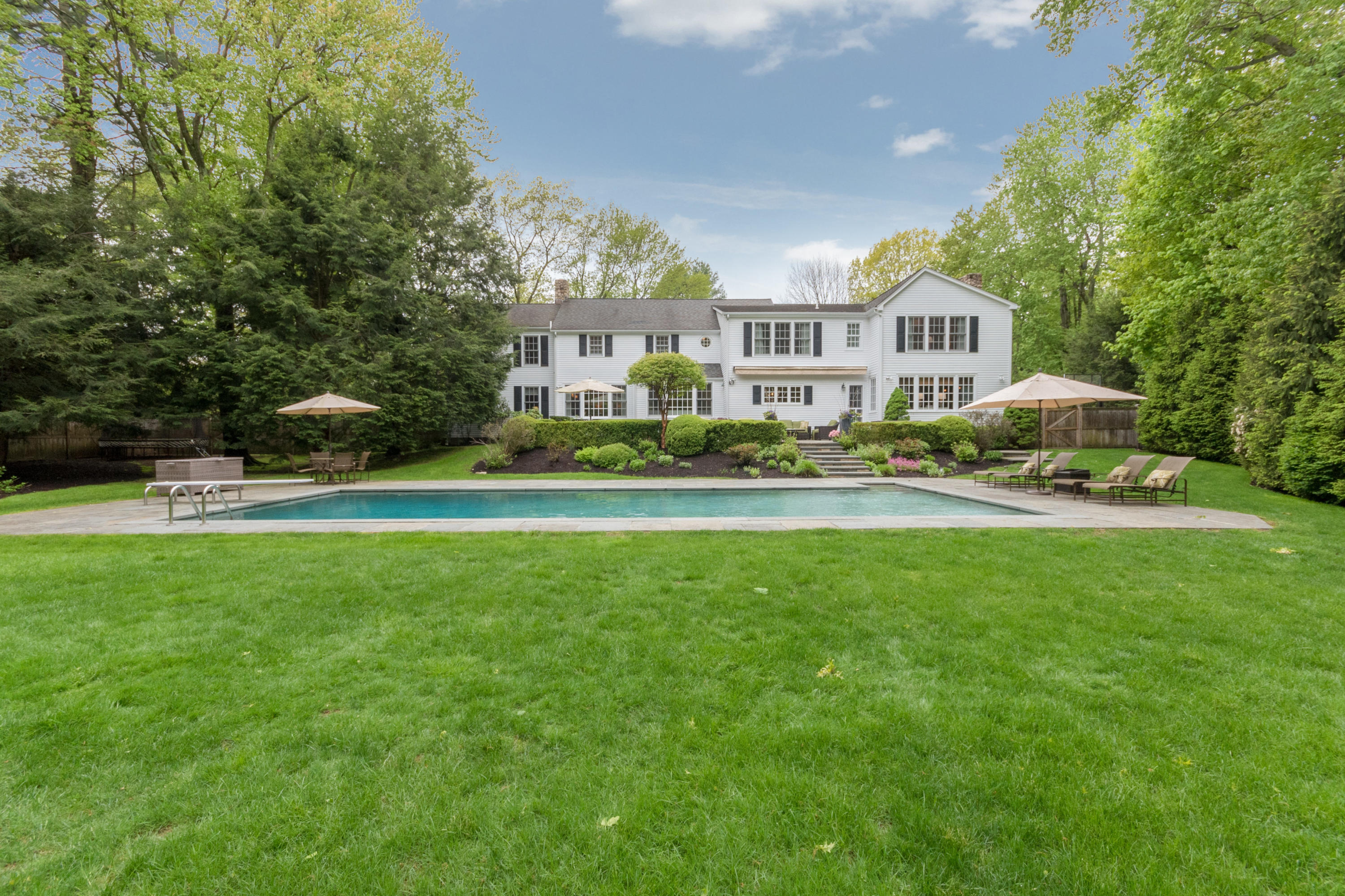 280 Hollow Tree Ridge Road Darien, CT 06820 - Photo 60 of 66 a front view of a house with a garden and trees