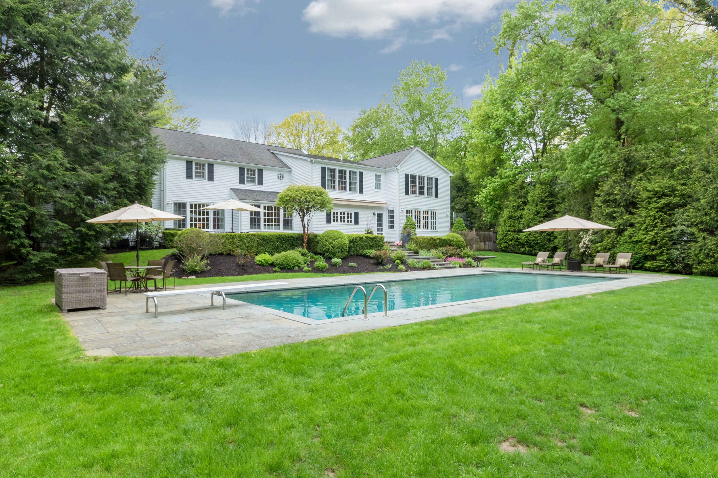 280 Hollow Tree Ridge Road Darien, CT 06820 - Photo 61 of 66 a view of a house with a yard table and chairs