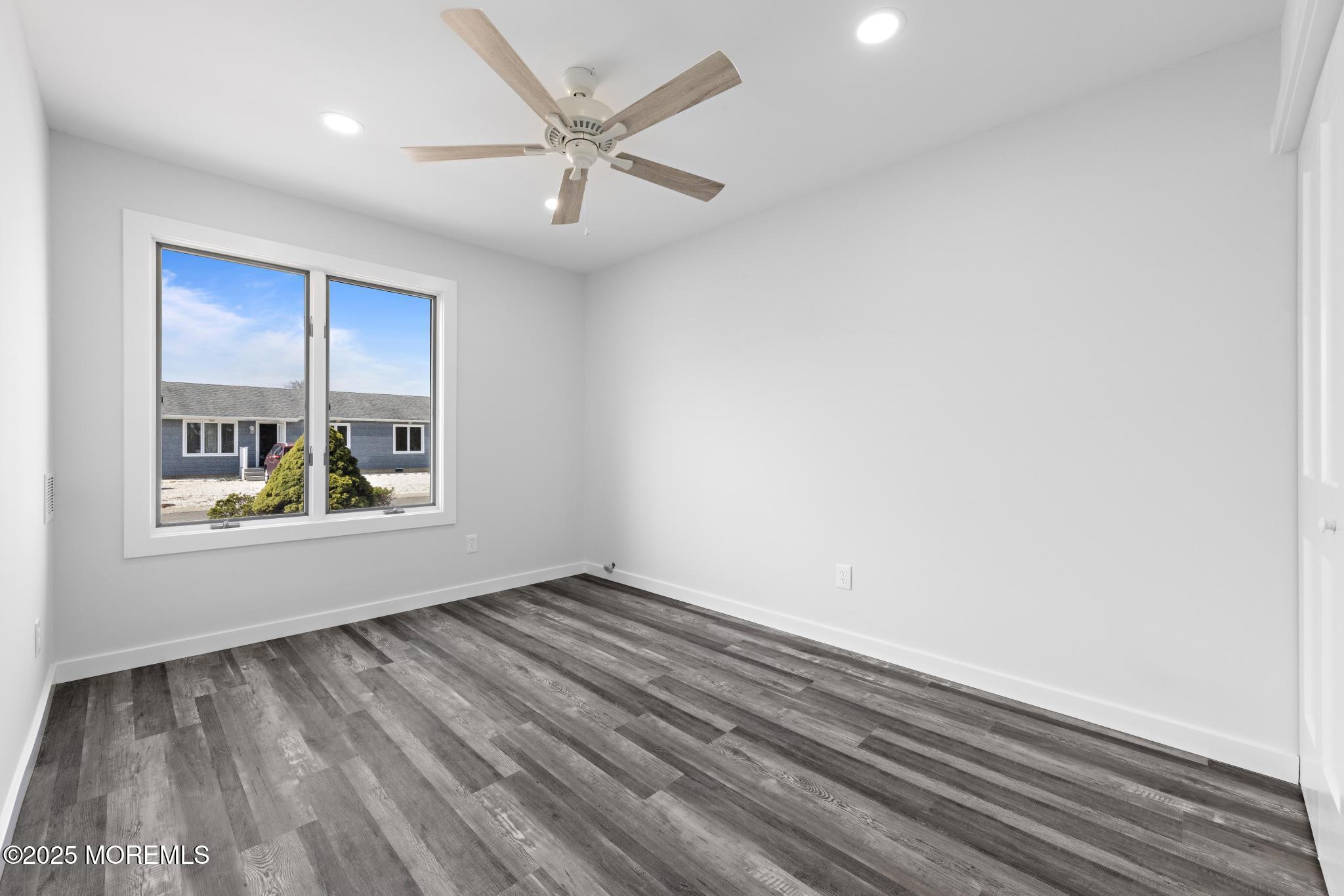157 Rodman Drive Beach Haven West, NJ 08050 - Photo 19 of 44 wooden floor in an empty room with a window