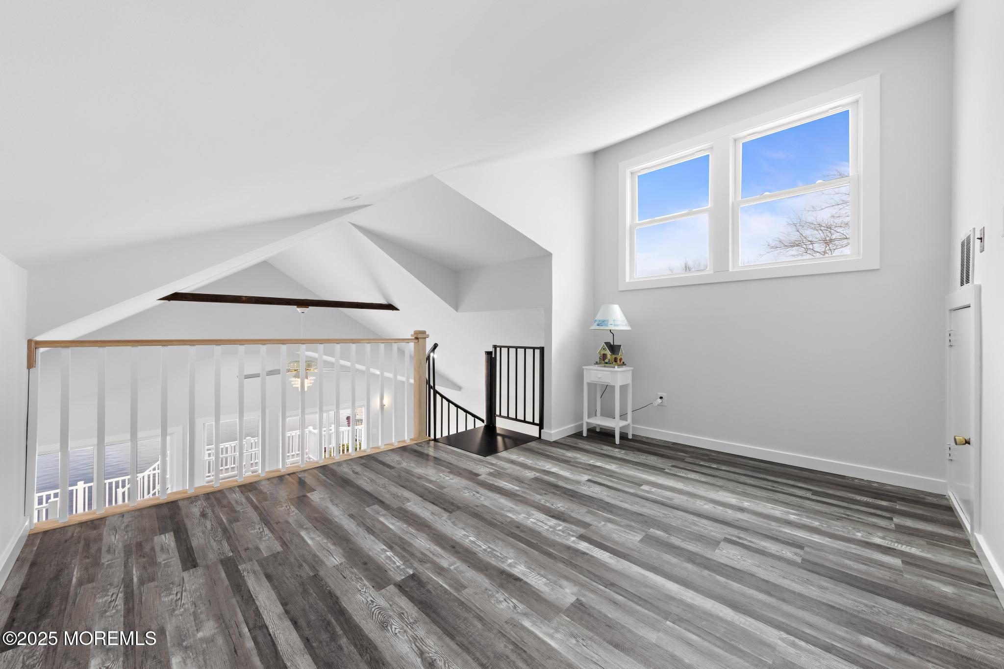 157 Rodman Drive Beach Haven West, NJ 08050 - Photo 21 of 44 a view of an empty room with wooden floor and a window