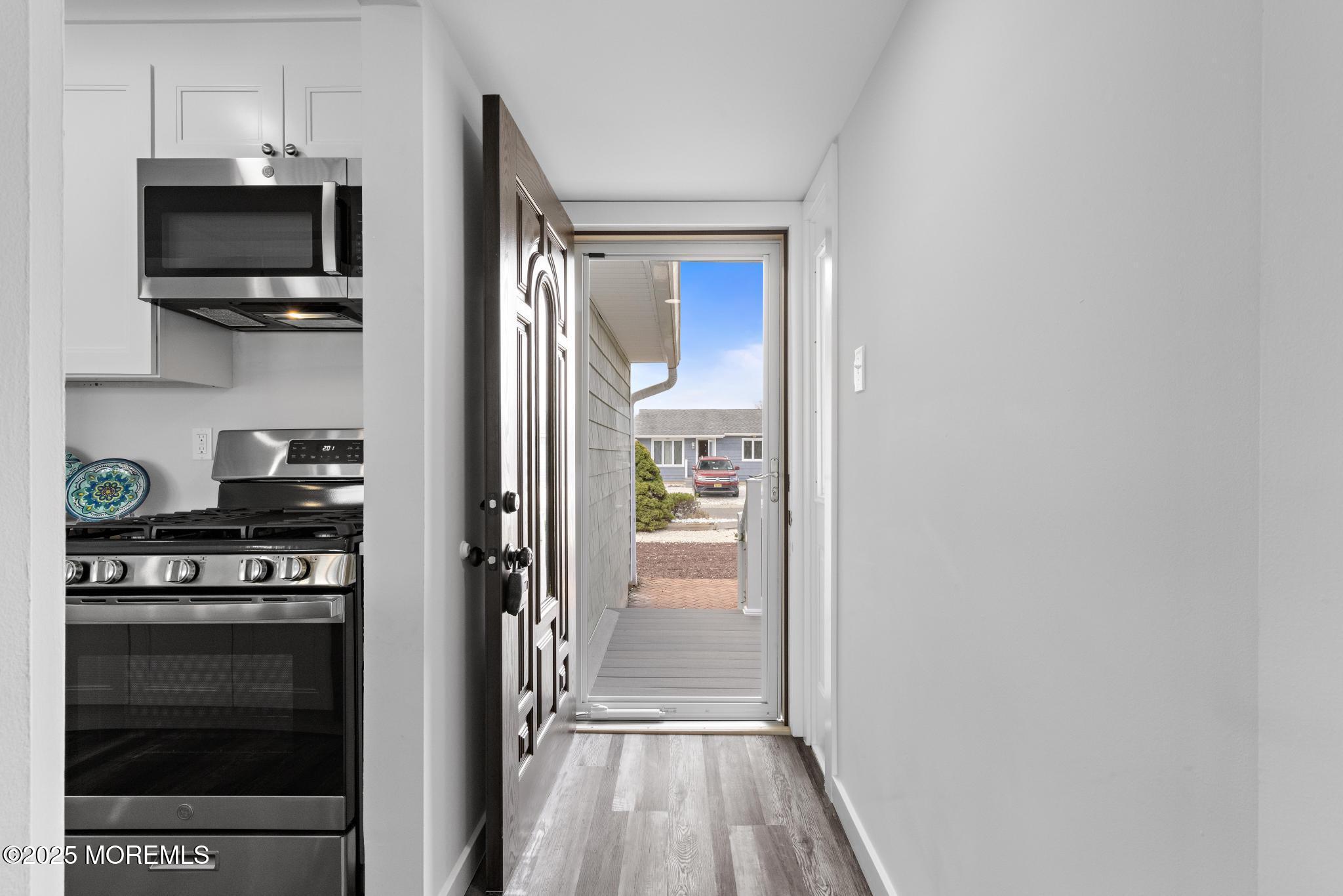 157 Rodman Drive Beach Haven West, NJ 08050 - Photo 24 of 44 a kitchen with white cabinets and stainless steel appliances
