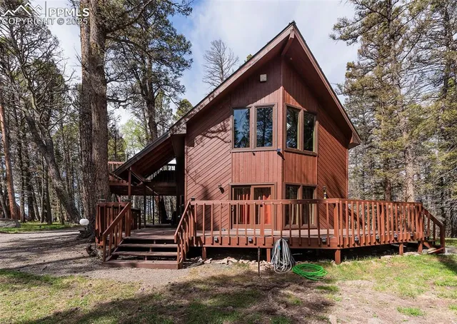 a front view of a house with a yard table and chairs