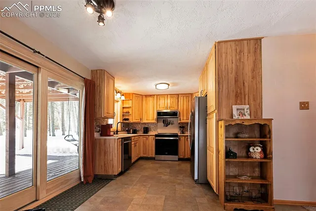 a kitchen with stainless steel appliances a refrigerator and a stove