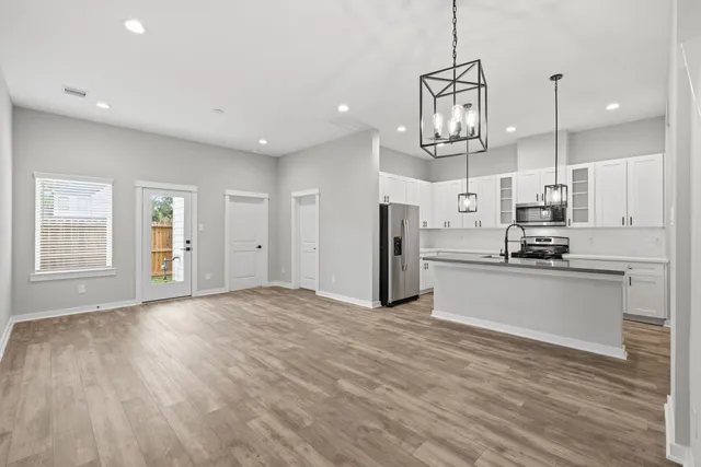 a view of large kitchen with refrigerator microwave and stove