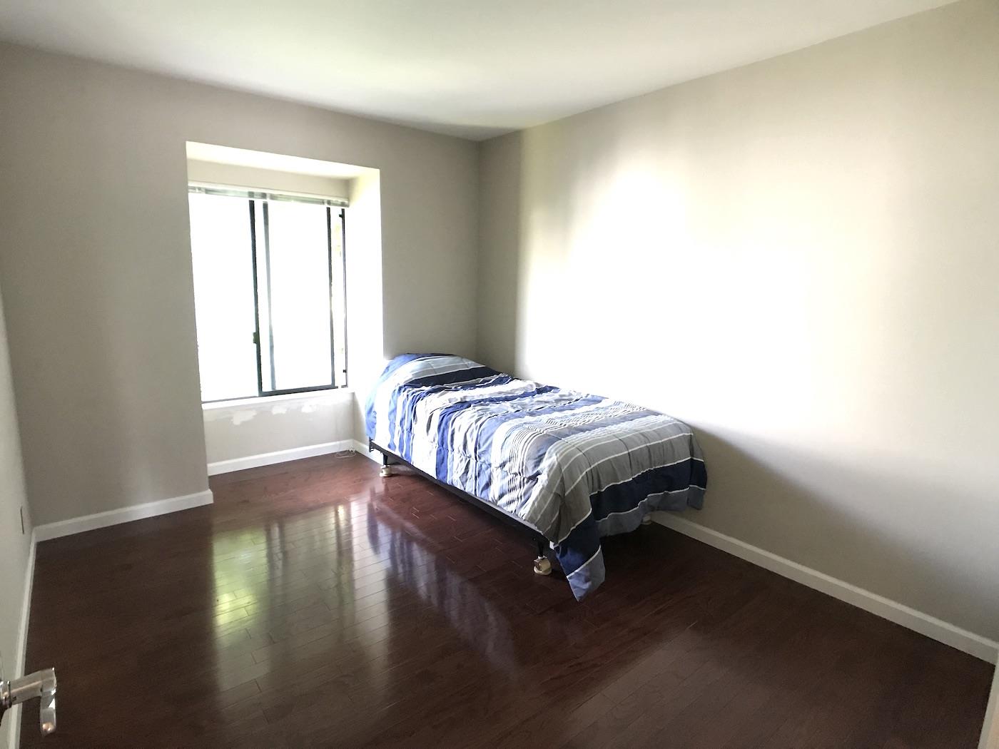1925 46th Avenue, Unit 60 Capitola, CA 95010 - Photo 11 of 26 a bedroom with a bed and wooden floor