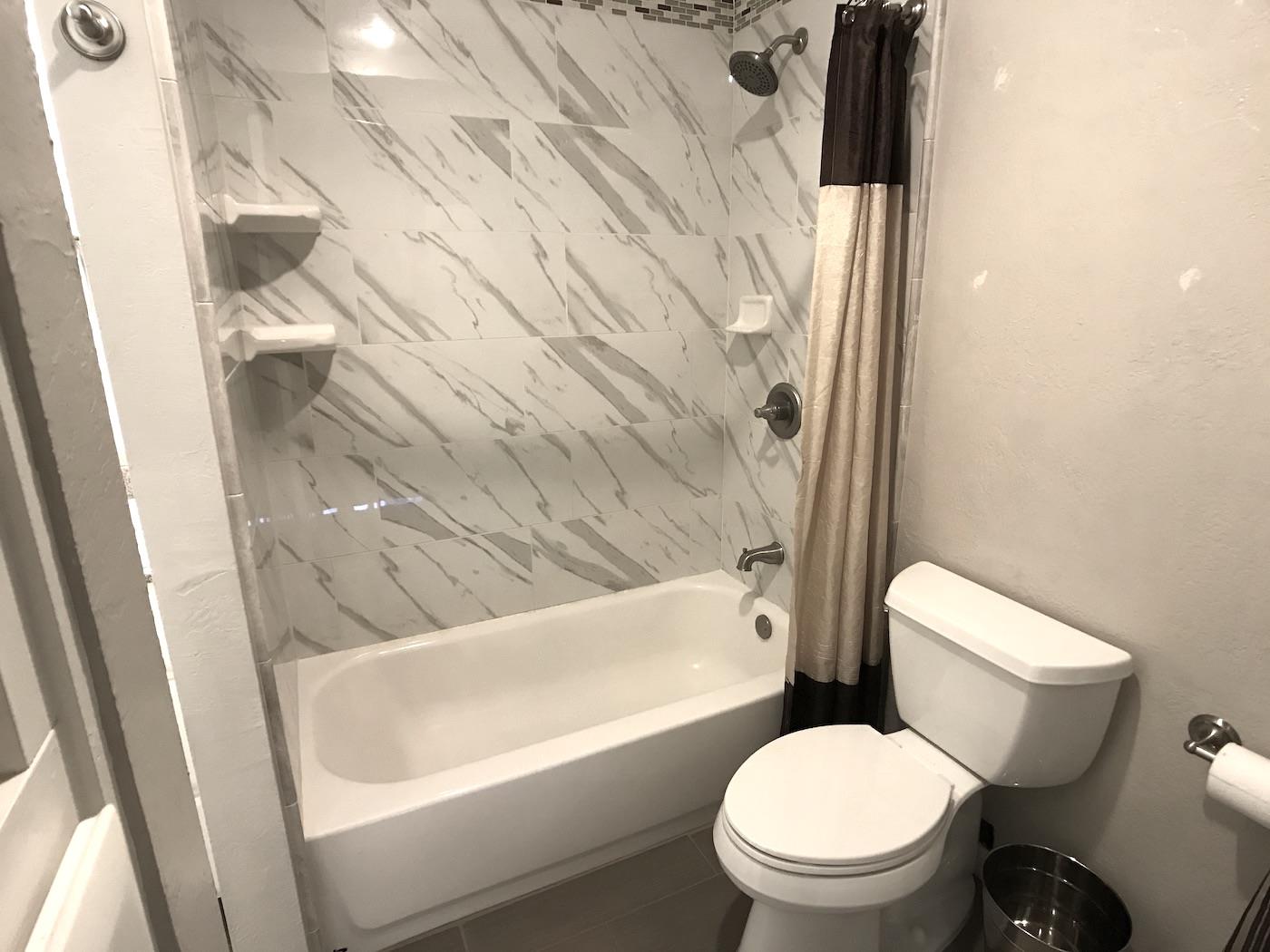 1925 46th Avenue, Unit 60 Capitola, CA 95010 - Photo 15 of 26 a white toilet sitting next to a bath tub