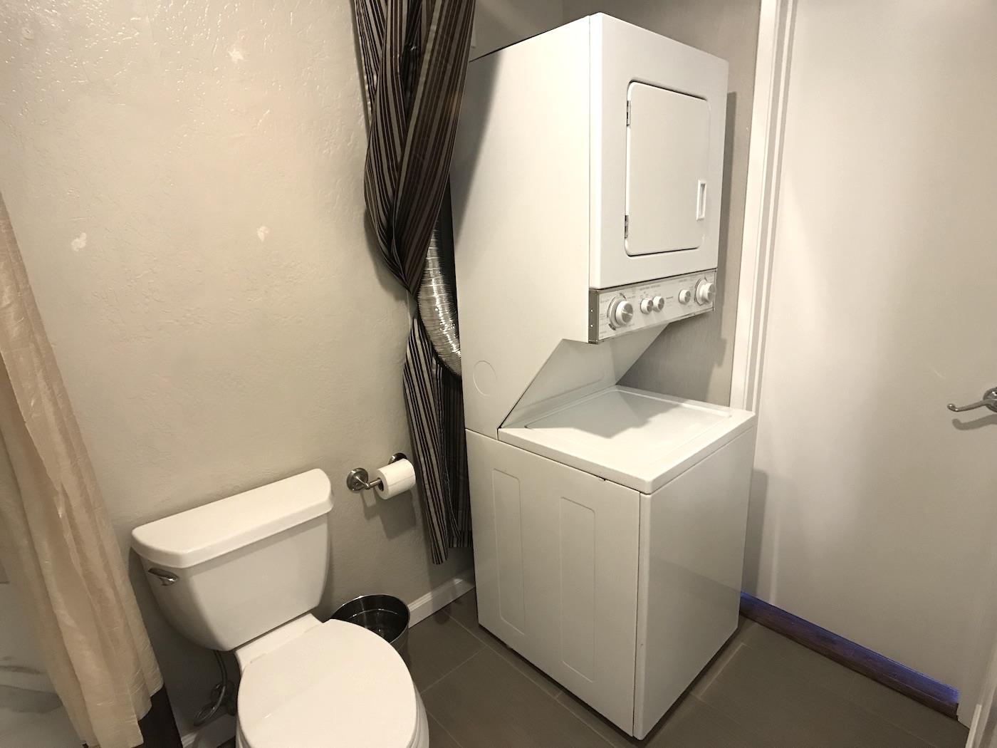 1925 46th Avenue, Unit 60 Capitola, CA 95010 - Photo 16 of 26 a white toilet sitting next to a bathroom sink