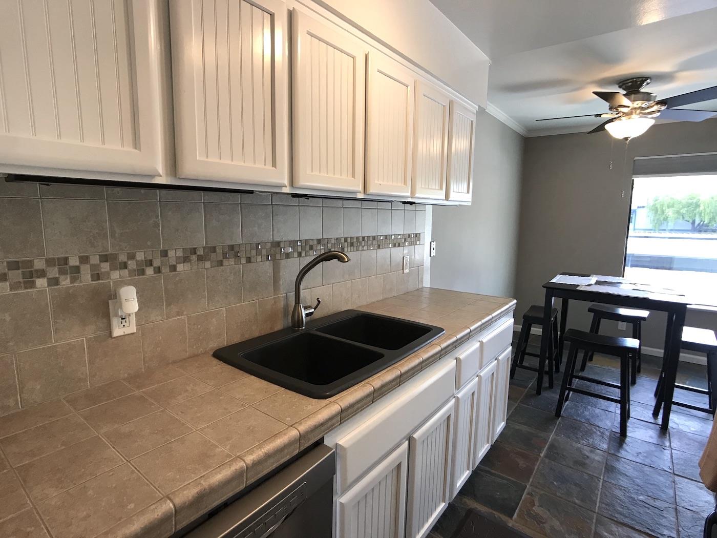 1925 46th Avenue, Unit 60 Capitola, CA 95010 - Photo 4 of 26 a kitchen with a sink and cabinets