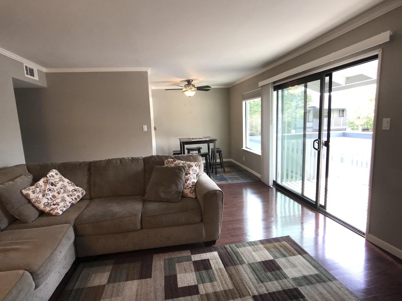 1925 46th Avenue, Unit 60 Capitola, CA 95010 - Photo 6 of 26 a living room with furniture and a floor to ceiling window