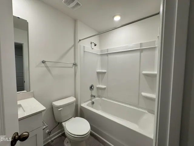 a bathroom with a toilet and a bathtub