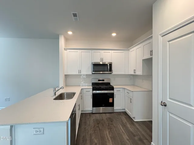 a kitchen with a sink stove and refrigerator