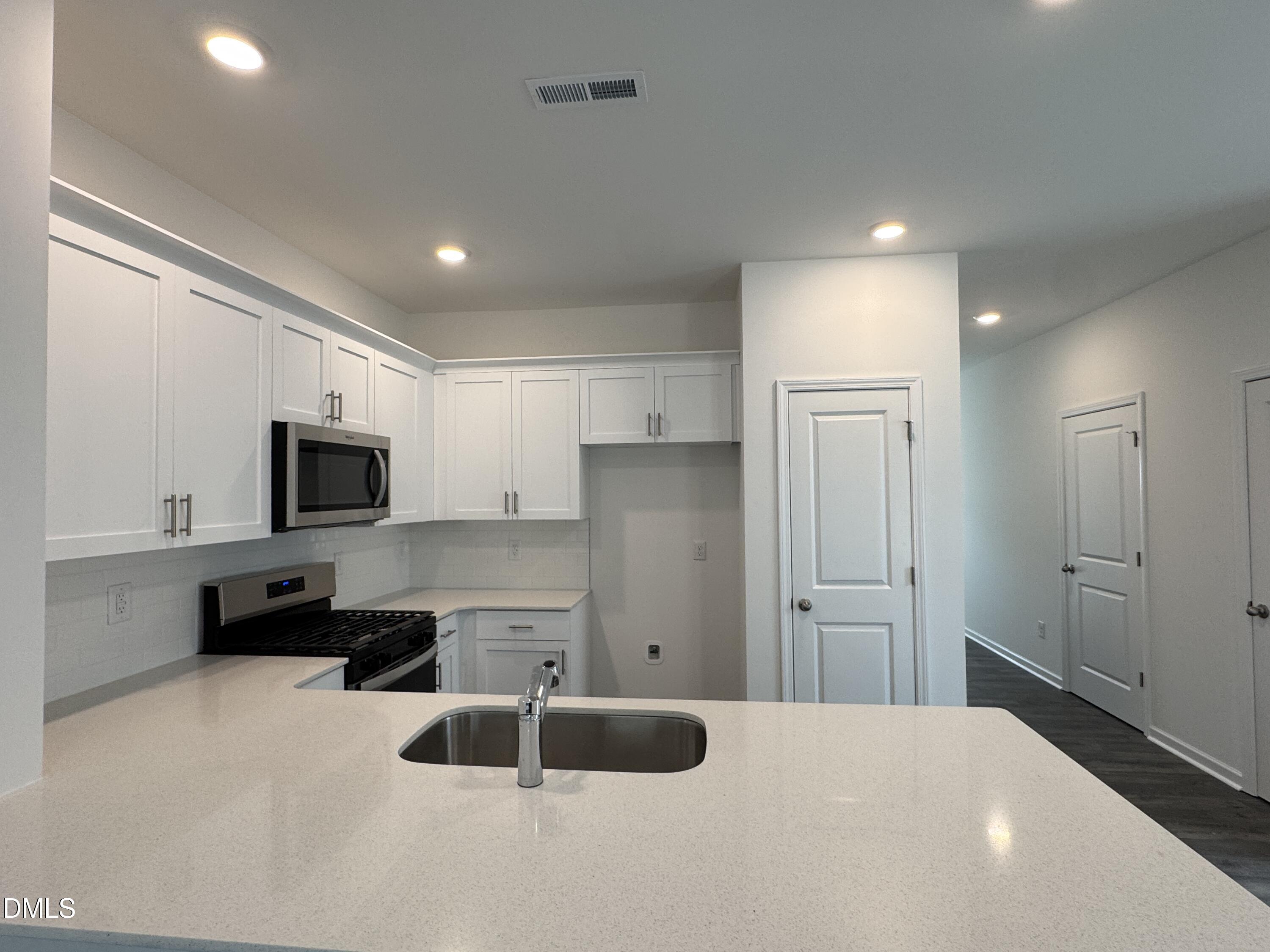 413 Belgian Red Way Wake Forest, NC 27587 - Photo 5 of 19 a kitchen with stainless steel appliances a refrigerator sink and microwave