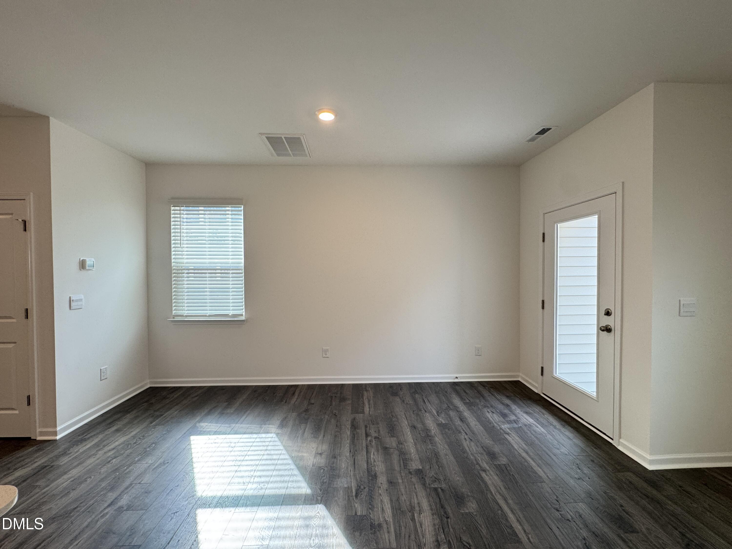 413 Belgian Red Way Wake Forest, NC 27587 - Photo 7 of 19 an empty room with wooden floor and windows