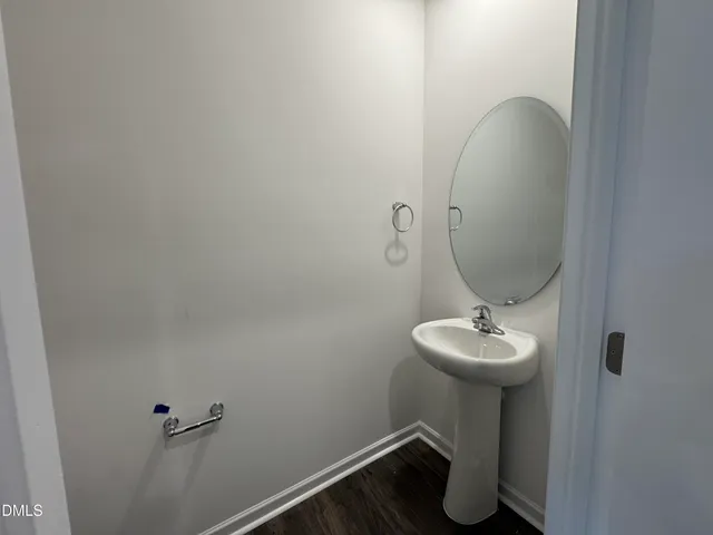 a bathroom with a sink toilet and mirror