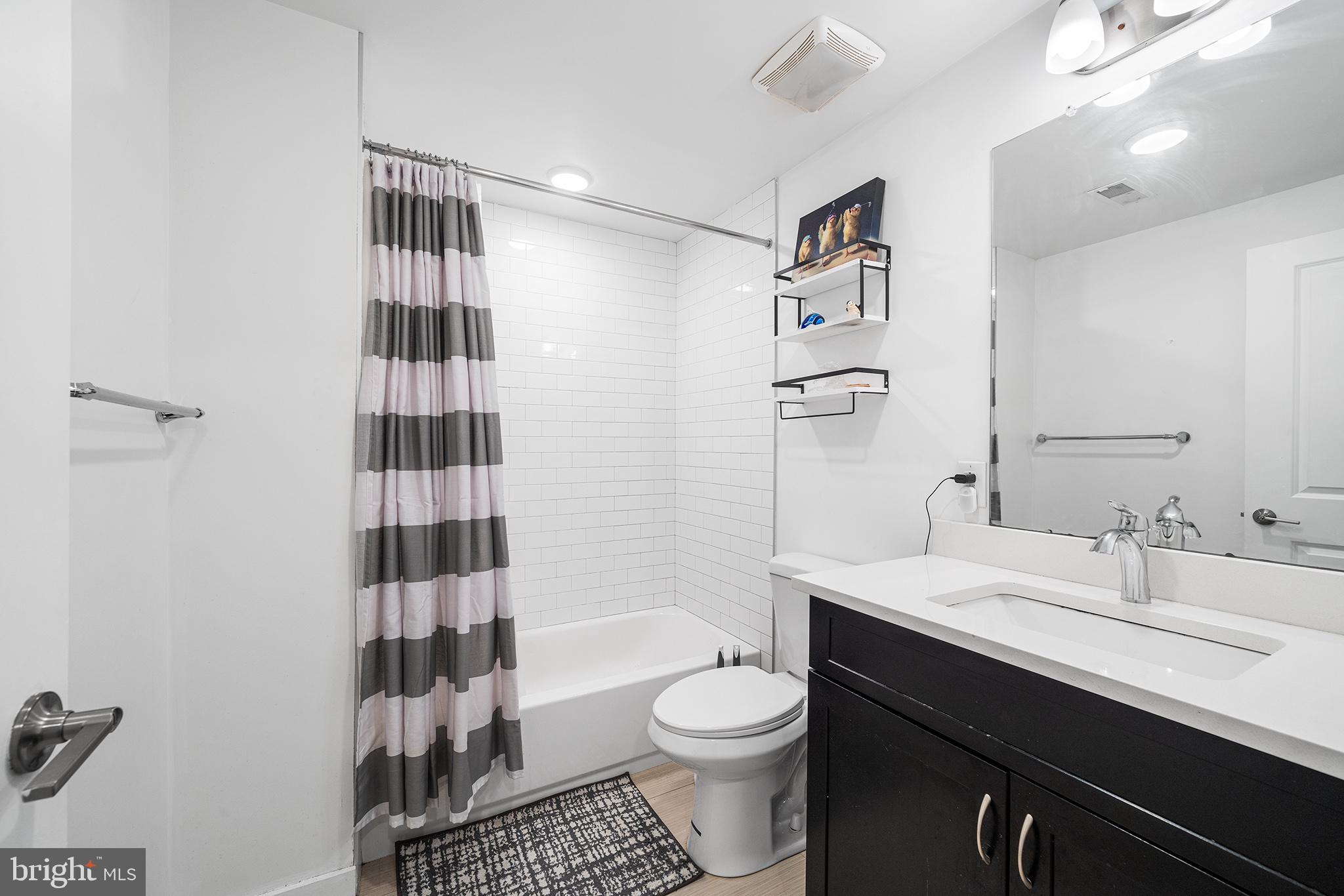 1640 North 5th Court, Unit 29A Philadelphia, PA 19122 - Photo 12 of 21 a bathroom with a sink a toilet a shower and a mirror