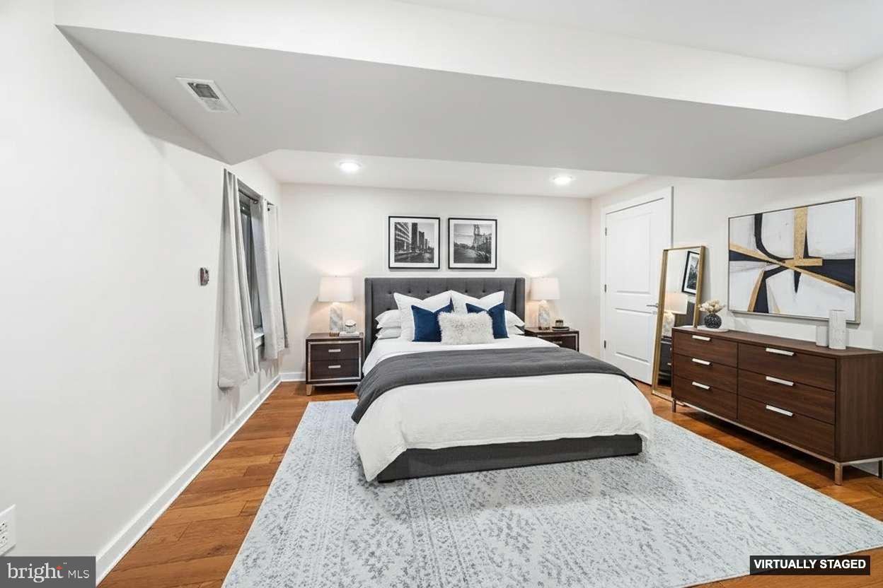 1640 North 5th Court, Unit 29A Philadelphia, PA 19122 - Photo 9 of 21 a spacious bedroom with a bed and closet with mirror