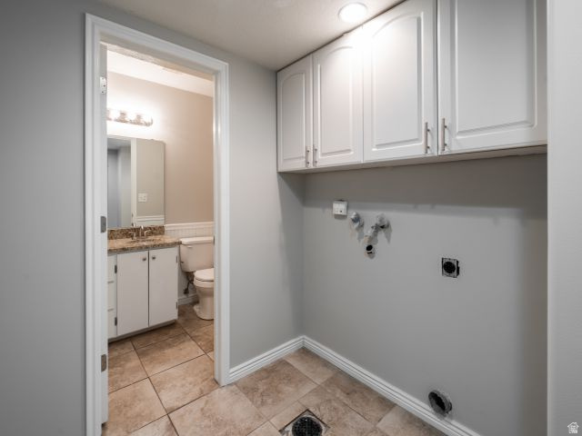 1446 West 1450 North Layton, UT 84041 - Photo 7 of 16 Utility space featuring overhead white cabinetry, light gray walls, and tile flooring