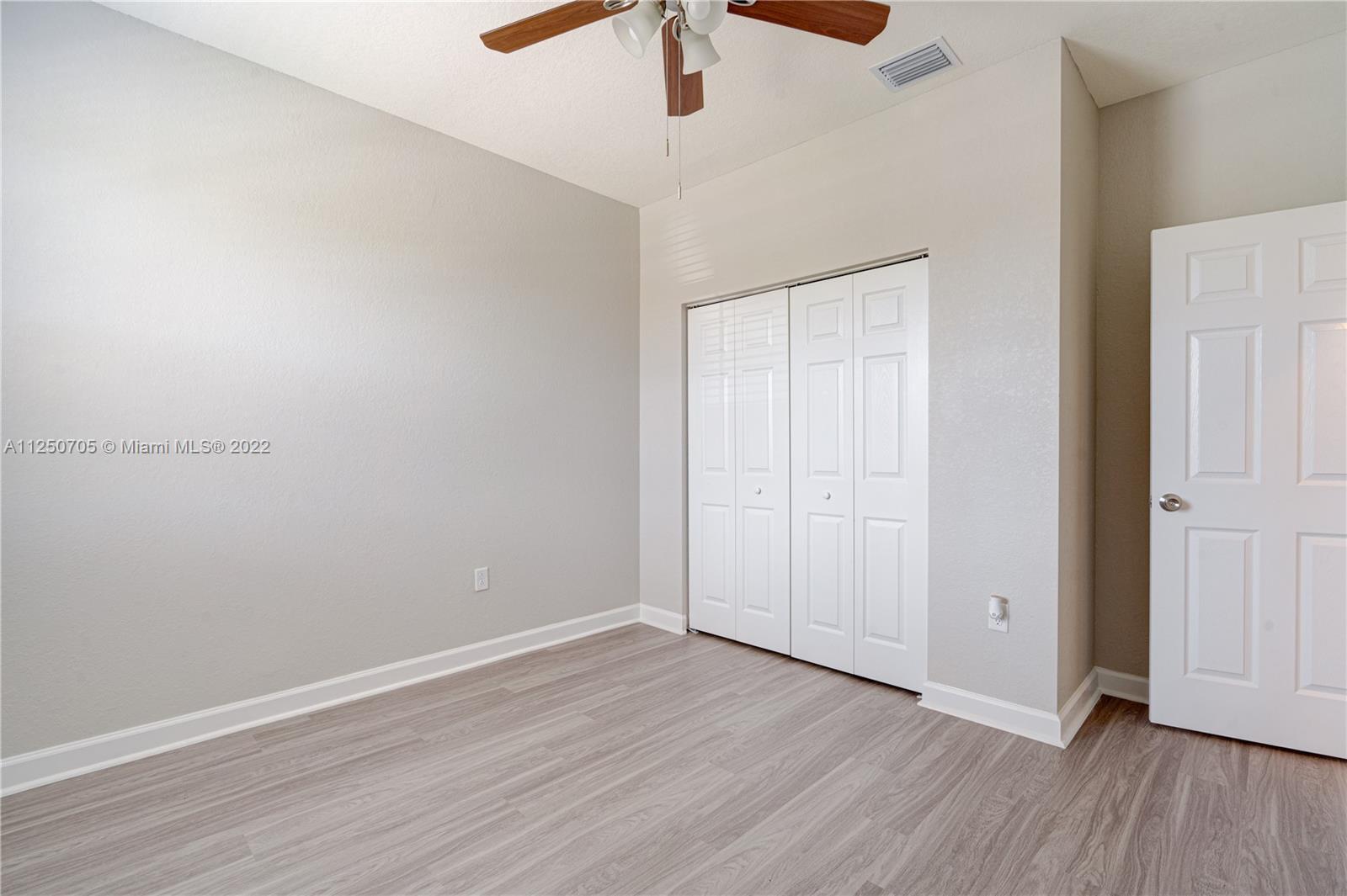124 Northeast 25th Avenue Homestead, FL 33033 - Photo 13 of 32 a view of an empty room with wooden floor